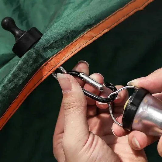 Magnetic carabiner securely attaching to a tent for convenient carrying.