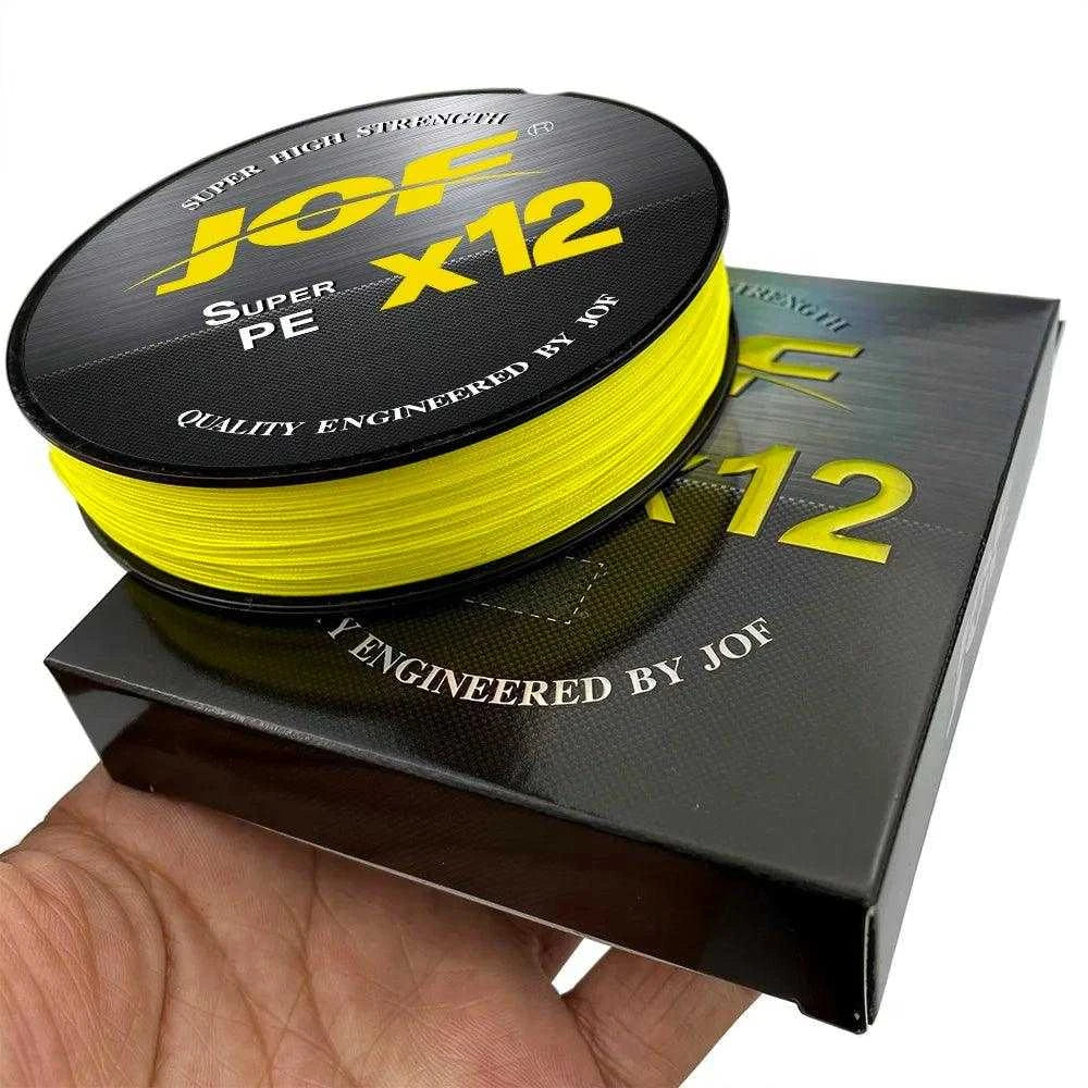 JOF X12 Braided 100m/300m super strong multifilament fishing line on hand, showing yellow spool with packaging.