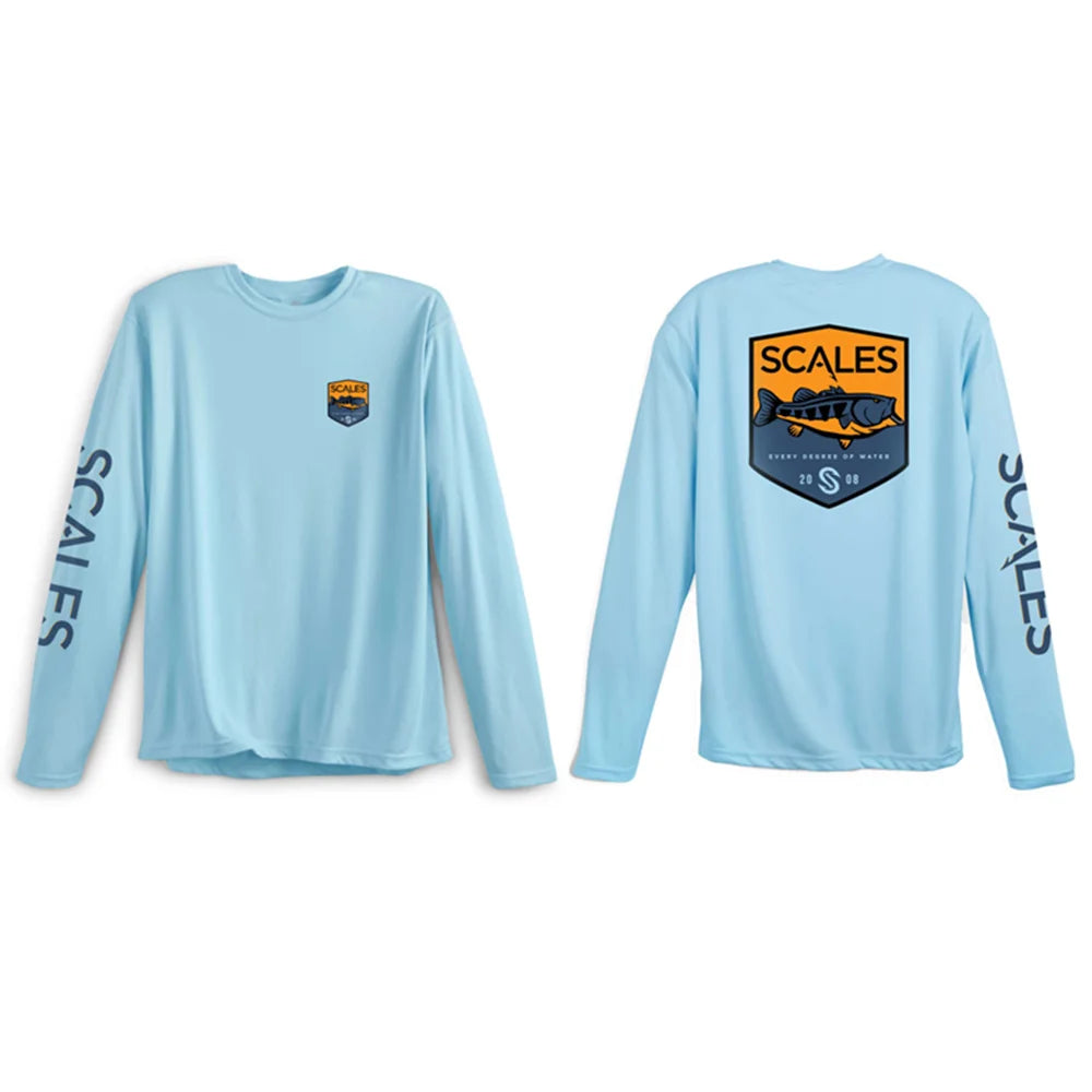 A light blue long-sleeve performance shirt shown from both the front and back. The front features a small shield logo on the left chest and 'SCALERS' printed down the right sleeve.