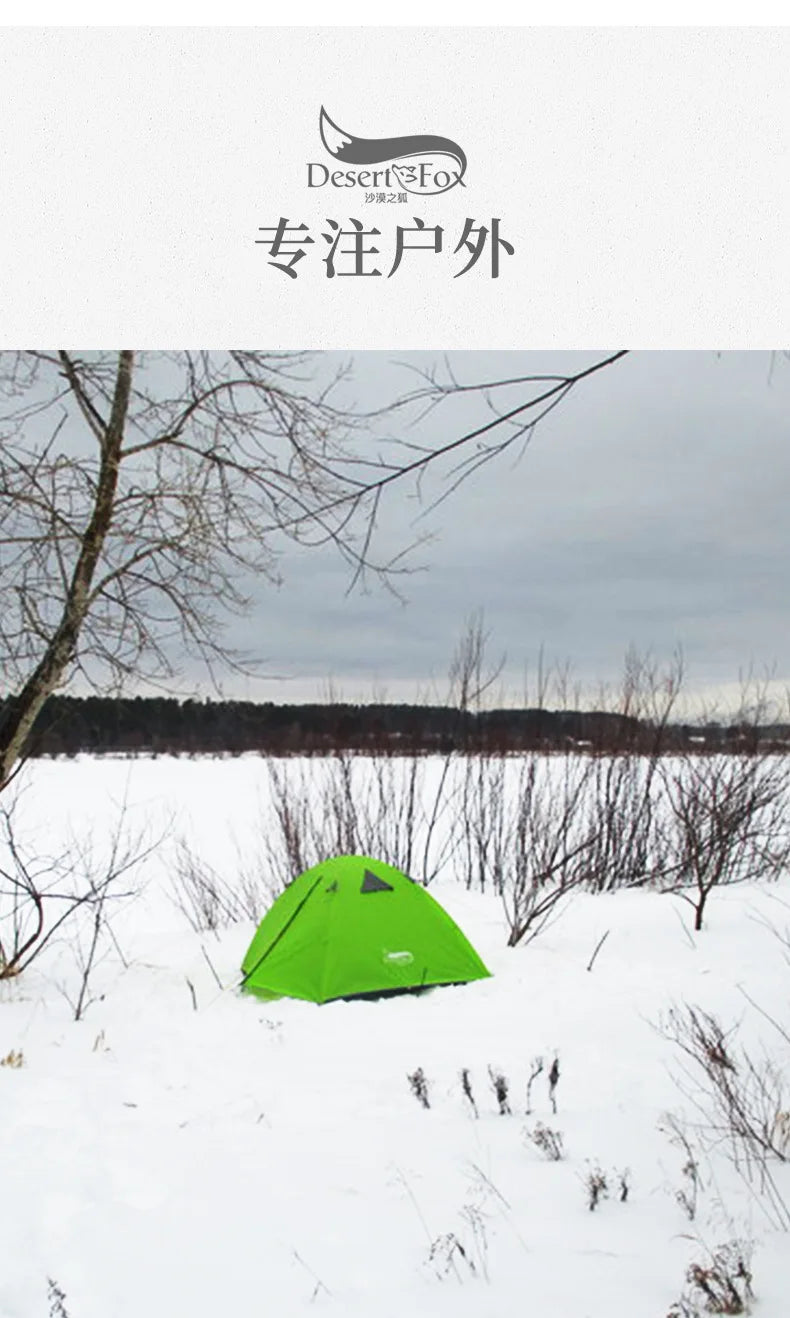 Green tent in a snowy landscape with bare trees and a cloudy sky.